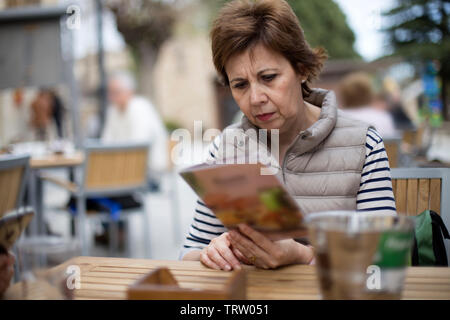 adult woman sitting outdoor  in a street cafe in Madrid, Spain Stock Photo