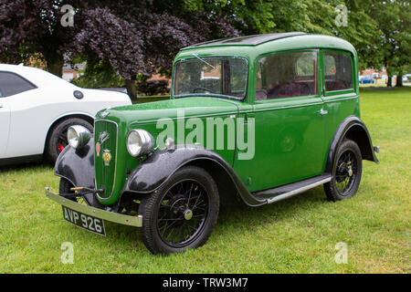 classic Austin 7 Ruby saloon car parked in car park among modern cars ...
