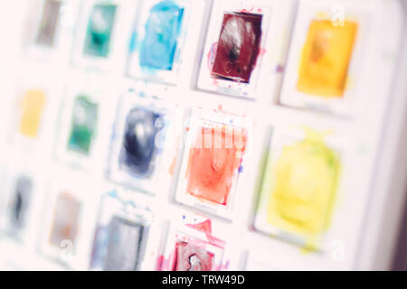 Background colored watercolor paints in white plastic box close up Stock Photo