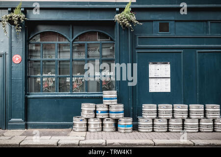 Dublin, Ireland - February 12, 2019 - beer barrels piled up on the street in front of an Irish pub on a winter day Stock Photo