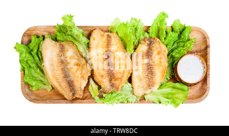 top view of fried ocean perch fillet on wooden tray isolated on white background Stock Photo