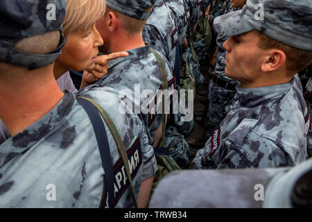 Moscow, Russia. 12th June, 2019 A woman argues with the police during unauthorized march to protest against the alleged impunity of law enforcement agencies in central Moscow, Russia Stock Photo