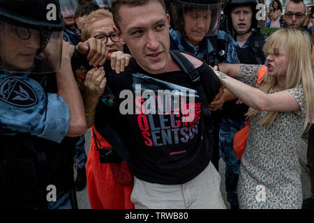 Moscow, Russia. 12th June, 2019 Police officers detain opposition activist Konstantin Kotov during a rally in support of Russian journalist Ivan Golunov who was earlier released from custody in Moscow, Russia. Golunov, who works for the online news portal Meduza, was detained on 6th June 2019 in central Moscow on suspicion of drug dealing Stock Photo