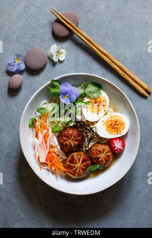 Japanese miso ramen with stuffed mushrooms, noodles and egg Stock Photo