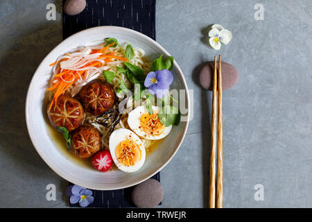 Japanese miso ramen with stuffed mushrooms, noodles and egg Stock Photo