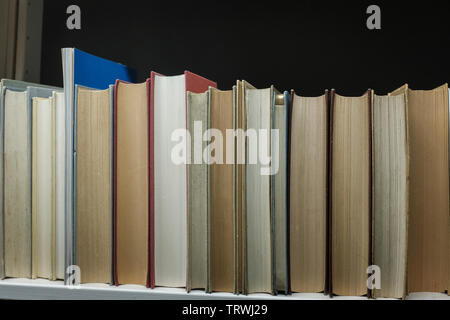 Books on a shelf in a home library Stock Photo