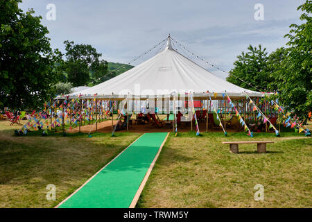 Relaxing and reading  at the Hay Literary Festival, Hay on Wye, Powys Stock Photo