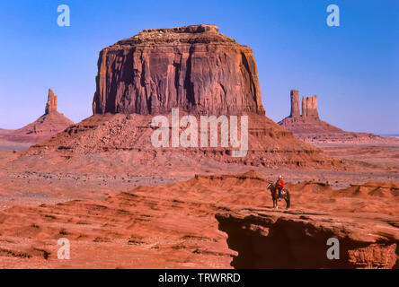 Navajo man on horseback in Navajo Tribal Park, Arizona and Utah. Colorful sandstone buttes. Stock Photo
