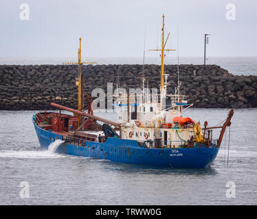 LANDEYJAHOFN, ICELAND - Ship dredging harbor at Westman Islands ferry terminal. Stock Photo