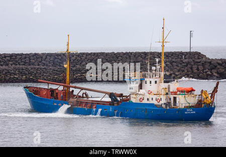 LANDEYJAHOFN, ICELAND - Ship dredging harbor at Westman Islands ferry terminal. Stock Photo