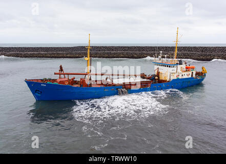 LANDEYJAHOFN, ICELAND - Ship dredging harbor at Westman Islands ferry terminal. Stock Photo