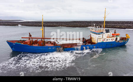 LANDEYJAHOFN, ICELAND - Ship dredging harbor at Westman Islands ferry terminal. Stock Photo