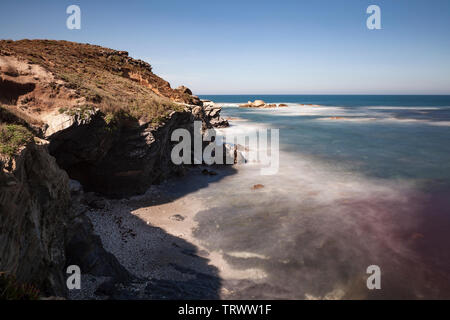 Fishermen's Route, in the southwest of Portugal, with its rock formations and crystalline water, with reddish tones that the algae gives to the water. Stock Photo