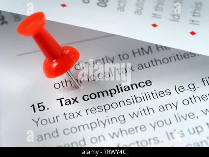 TAX COMPLIANCE LITERATURE WITH RED BOARD PIN RE TAXATION TAXES AVOIDANCE EVASION SELF ASSESSMENT HMRC ETC UK Stock Photo