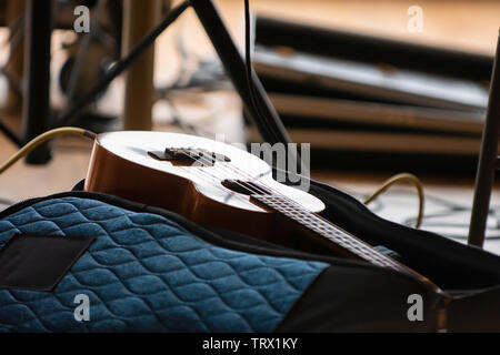 A Ukulele lays on its case; plugged in and ready to go. Stock Photo