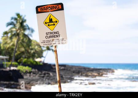 A sing on the beach stating Warning Strong Current; Kona, Hawaii. Stock Photo