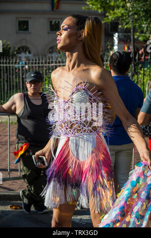 NEW YORK CITY - JUNE 25, 2017: A transgender woman wears an eye-catching outfit as she passes the crowds at the gay pride parade in the Village. Stock Photo