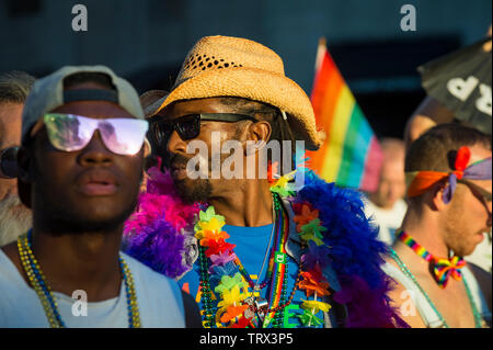 NEW YORK CITY - JUNE 25, 2017: Supporters wear flamboyant rainbow colored accessories in the annual gay Pride Parade in Greenwich Village. Stock Photo