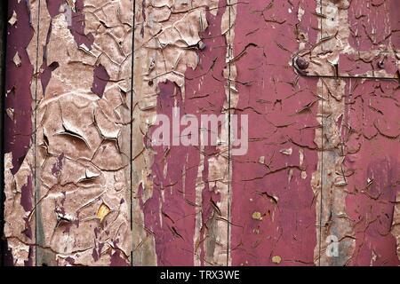 Detailed close up view on colorful peeling paint on aged and weathered concrete walls Stock Photo