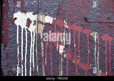 Detailed close up view on colorful peeling paint on aged and weathered concrete walls Stock Photo