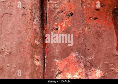 Detailed close up view on colorful peeling paint on aged and weathered concrete walls Stock Photo