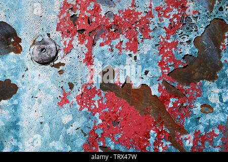 Detailed close up view on colorful peeling paint on aged and weathered concrete walls Stock Photo