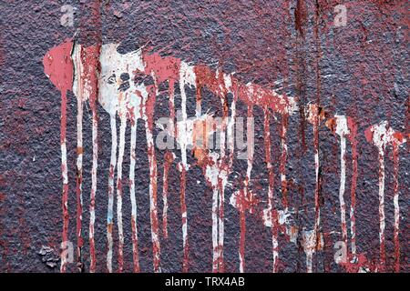 Detailed close up view on colorful peeling paint on aged and weathered concrete walls Stock Photo