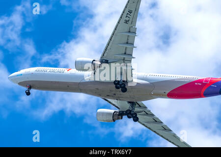 Passenger airplane Airbus A330 of Asiana Airlines flying through clouds sky take off from Tan Son Nhat International Airport, Ho Chi Minh City, Vietna Stock Photo