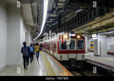 Osaka, Japan - Apr 18, 2019. Train stopping at railway station in Osaka, Japan. Trains are a very convenient way for visitors to travel around Japan. Stock Photo