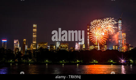 New York, USA,  12 June 2019. Fireworks illuminate the sky over Central Park after a concert by the New York Philharmonic orchestra.  Credit: Enrique Shore/Alamy Live News Stock Photo