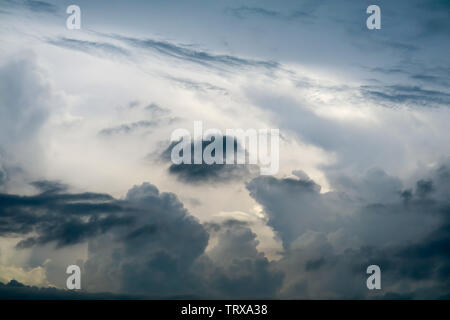storm silhouette heap cloud sun ray in gray skycape black cloud background Stock Photo