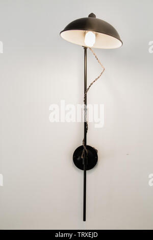 black color metal sconce closeup on white wall Stock Photo