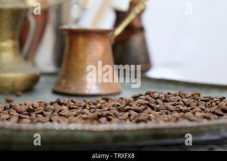Coffee beans on a copper plate and old turkish coffee pot. Old cafe in Istanbul Stock Photo