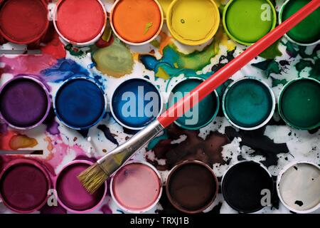Box of watercolors on a table. Stock Photo