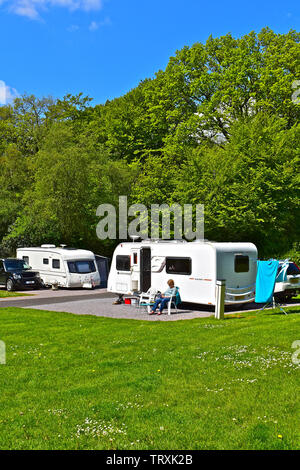 A view of modern caravans on site at Putts Corner, a rural campsite run by the Caravan & Motorhome Club, near Honiton, Devon. Quiet woodland location. Stock Photo