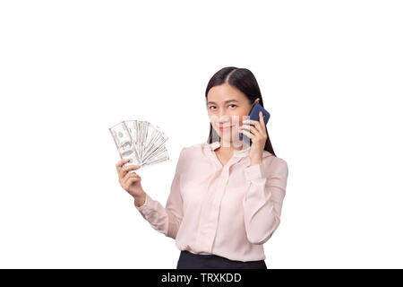 Asian beautiful woman holding banknote money in hand and mobile phone in another hand isolated on white background with clipping path.  commercial bus Stock Photo