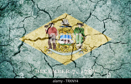 State of Delaware flag, state located in the Mid-Atlantic region of the United States, on dry earth ground texture background Stock Photo