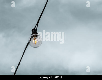 Elegant decorative bulb incandescent light against a cloudy sky. Stock Photo