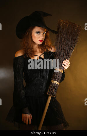 Naked Black Halloween Witch on a Broom Stick Flying Past the Moon Stock