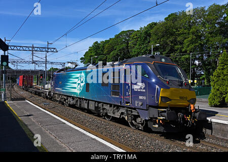 Direct Rail Services Class 88 locomotive No.88010 'Aurora' hauling mixed freight on the West Coast Mainline. Oxenholme, Cumbria, England, United Kingd Stock Photo