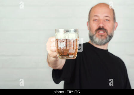 man drinking beer on brick background Stock Photo