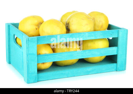 Sweet quinces in wooden box isolated on white Stock Photo