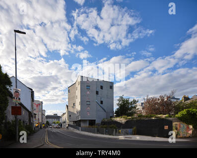 Distant elevation from south with street and street grafitti. Pálás Cinema, Galway, Ireland. Architect: dePaor, 2017. Stock Photo