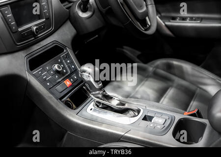 Gear Lever or Shift Lever with cup holder and air condition control in modern car. Stock Photo