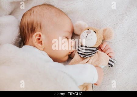 baby sleeping with stuffed toy Stock Photo