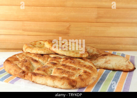 Pita breads on tablecloth on wooden background Stock Photo