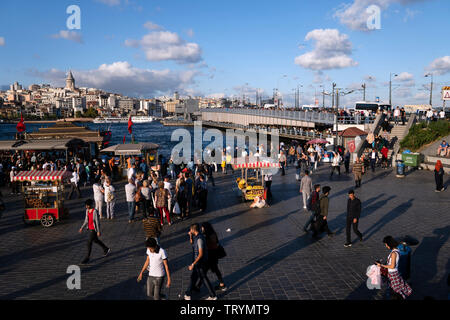 Istanbul, Turkey - September 20, 2018 :A little square near The Galata Bridge. There are street food sellers, a tourist group and many Turkish people. Stock Photo