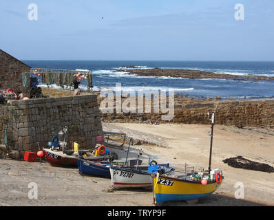 Colourful fishing boats hauled up on to the quay at Sennen Cove, Cornwall, England Stock Photo