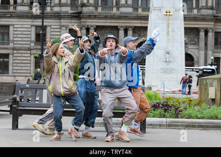 Glasgow, UK. 13 June 2019. Lunchtime crowds in Glasgow's George Square were treated to free dance show by the performers of 'WASTELAND' dance troupe, a high energy theatre marking the 25th anniversary of the demolition of Grimethorpe Colliery in South Yorkshire and 30 years since the rise of the UK rave culture. The Scottish premier is at Glasgow's Tramway theatre on 14th and 15th June. Credit: Findlay/Alamy Live News Stock Photo