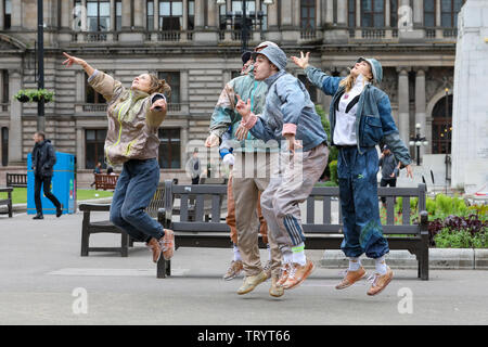 Glasgow, UK. 13 June 2019. Lunchtime crowds in Glasgow's George Square were treated to free dance show by the performers of 'WASTELAND' dance troupe, a high energy theatre marking the 25th anniversary of the demolition of Grimethorpe Colliery in South Yorkshire and 30 years since the rise of the UK rave culture. The Scottish premier is at Glasgow's Tramway theatre on 14th and 15th June. Credit: Findlay/Alamy Live News Stock Photo